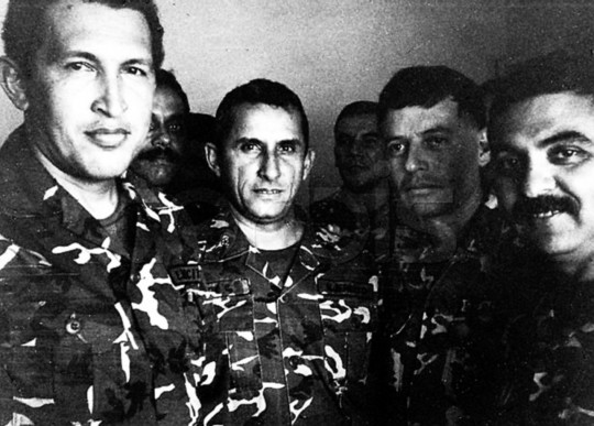 Venezuelan President Hugo Chavez (L) is shown in a 1992 file photo in jail after being arrested for a coup attempt. He stands next to Francisco Arias (2nd R), who is currently running for president, and former police chief Jesus Urdanetta (back center). According to some military insiders, Chavez, the strong favorite to win the July 30 vote, has upset many within the armed forces with his leftist rhetoric, populist policies and meddling in the military's affairs.   REUTERS/str/File photo REUTERS --- Image by © Reuters/CORBIS
